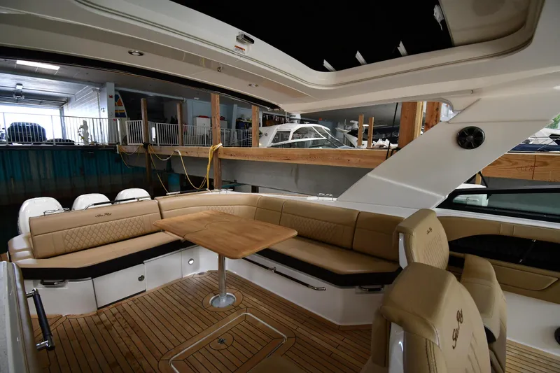 Slide: The Image of Luxurious interior of 2020 Sea Ray SLX 400 Outboard with elegant seating and wooden table. - 20