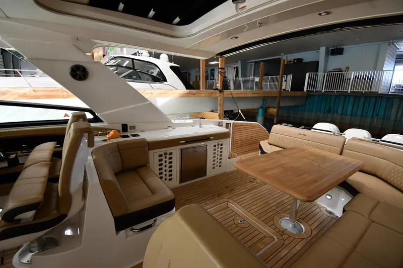 Slide: The Image of Luxurious interior of 2020 Sea Ray SLX 400 Outboard with elegant seating and wooden table. - 21