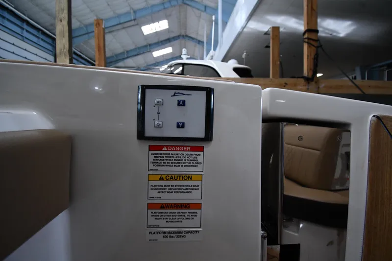 Slide: The Image of Control panel and safety warnings on a 2020 Sea Ray SLX 400 Outboard boat. - 28