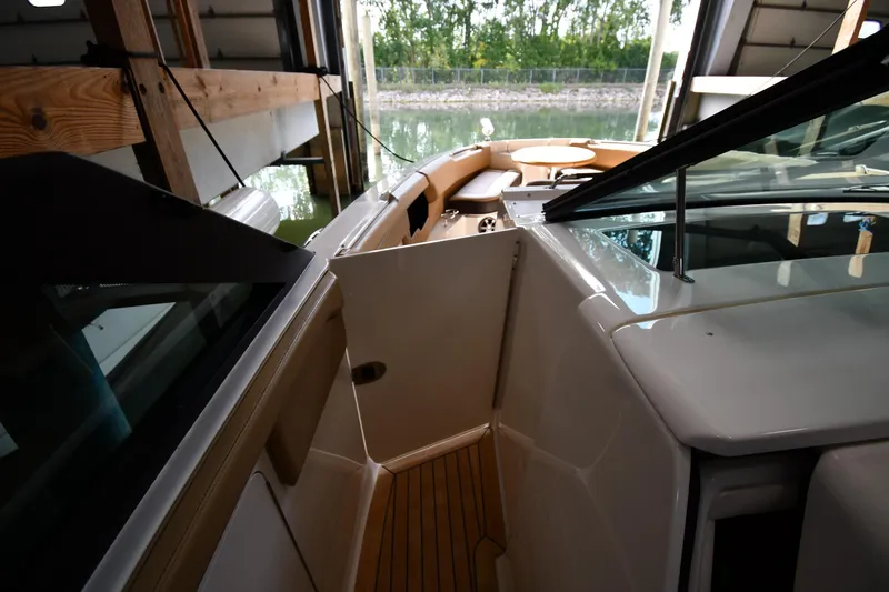 Slide: The Image of 2020 Sea Ray SLX 400 Outboard interior with open door, docked in a boathouse. - 32