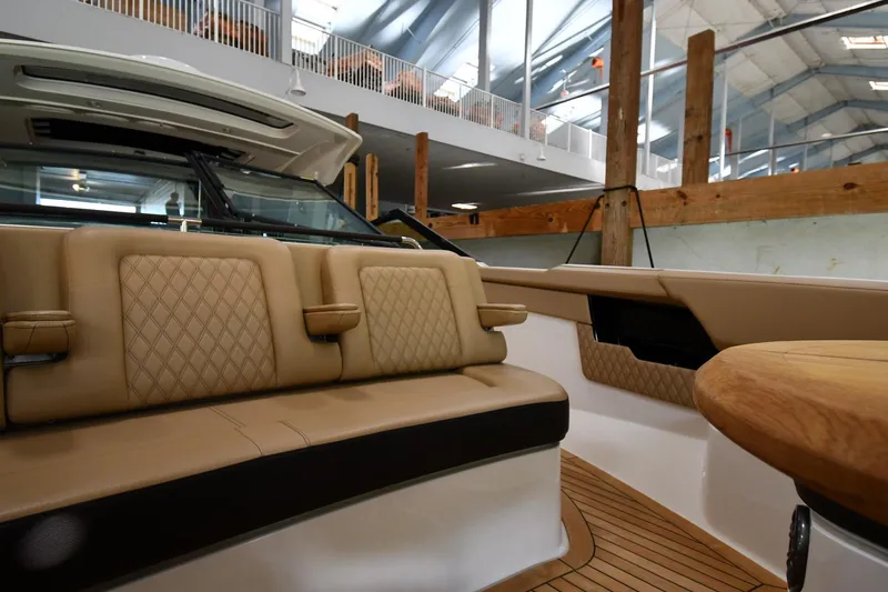 Slide: The Image of Luxurious interior of 2020 Sea Ray SLX 400 Outboard with tan leather seating and wood accents. - 35