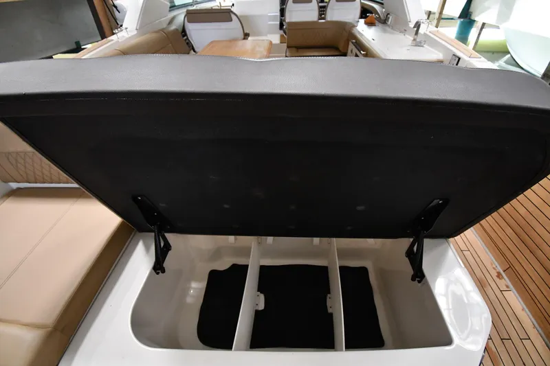 Slide: The Image of 2020 Sea Ray SLX 400 Outboard boat interior storage compartment open. - 38