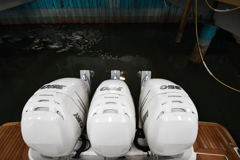 Slide: The Image of Triple outboard engines on a 2020 Sea Ray SLX 400, docked in a marina. - 4