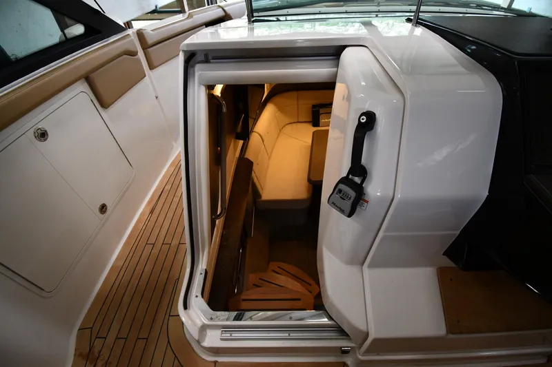 Slide: The Image of 2020 Sea Ray SLX 400 Outboard cabin entrance with teak flooring and modern interior. - 48