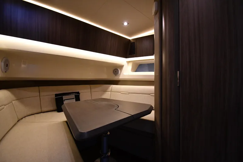 Slide: The Image of Luxurious interior of 2020 Sea Ray SLX 400 Outboard with elegant seating and table. - 52