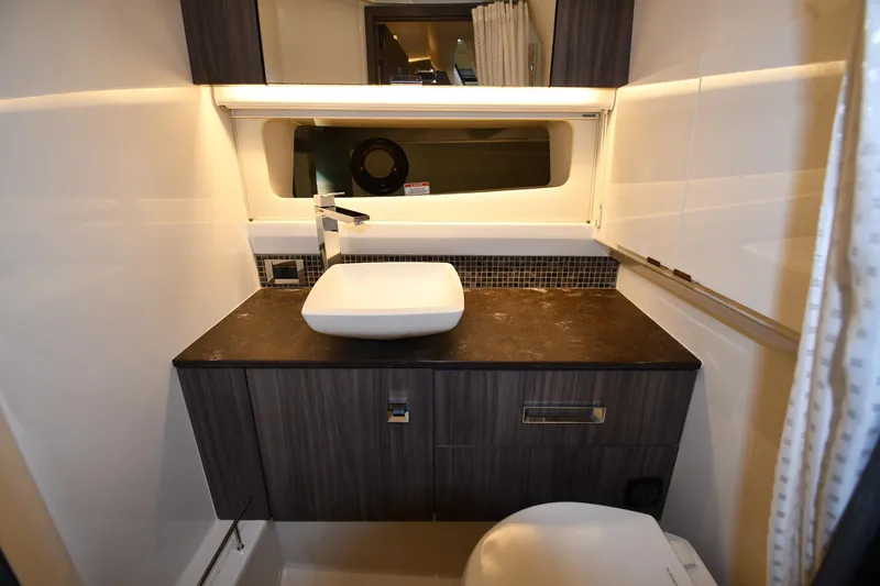 Slide: The Image of Luxurious bathroom interior of 2020 Sea Ray SLX 400 Outboard yacht, featuring modern sink and cabinetry. - 63