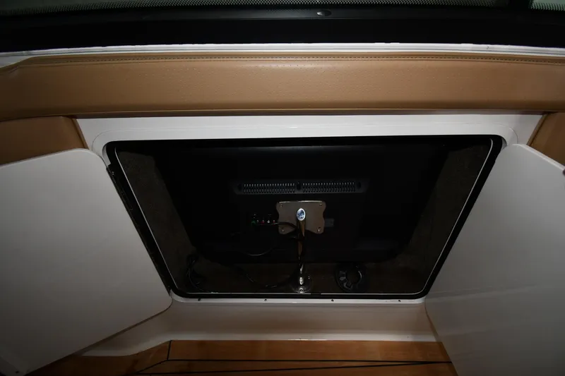 Slide: The Image of 2020 Sea Ray SLX 400 Outboard storage compartment with open door, showcasing interior details. - 64