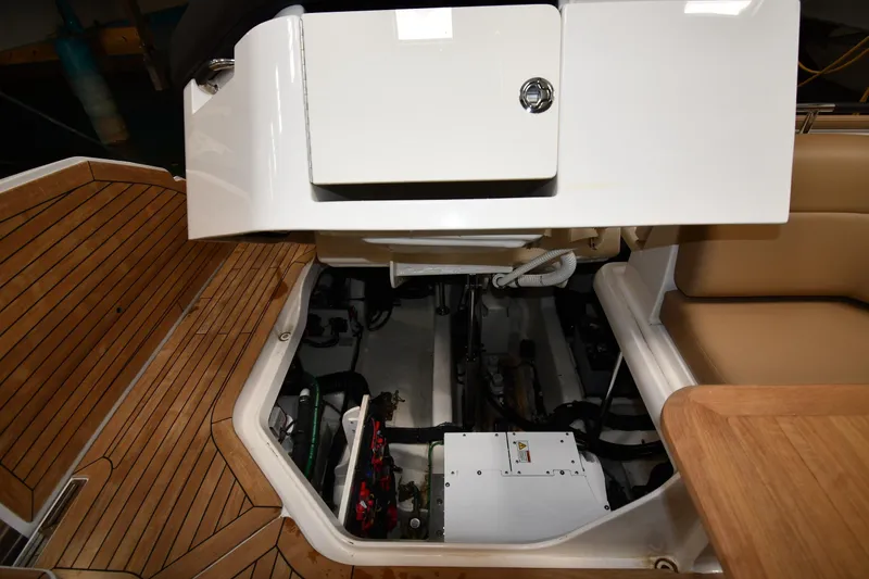 Slide: The Image of 2020 Sea Ray SLX 400 Outboard engine compartment with teak flooring and seating area. - 66