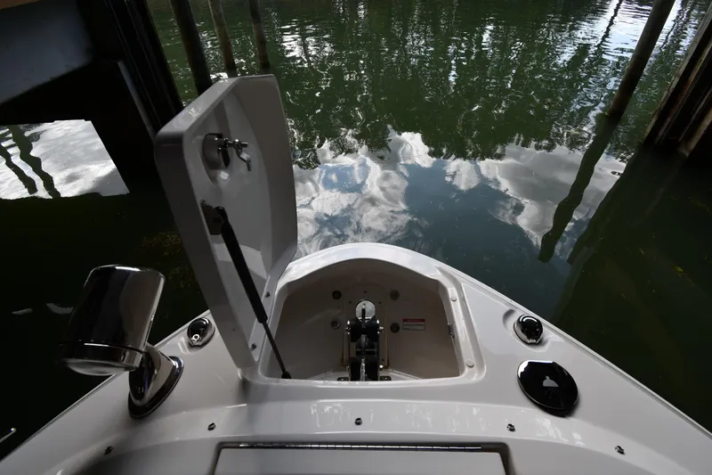 Slide: The Image of 2020 Sea Ray SLX 400 Outboard boat with open hatch, docked on calm water. - 7
