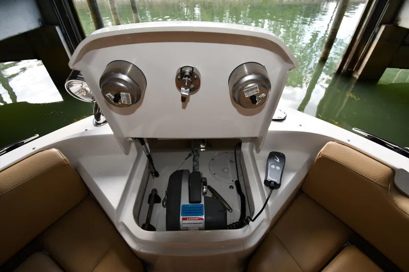 Slide: The Image of 2020 Sea Ray SLX 400 Outboard boat interior with storage compartment and remote control. - 8