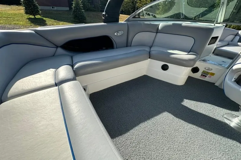 Slide: The Image of 2006 Centurion Enzo SV230 boat interior with gray seating and carpeted floor. - 13