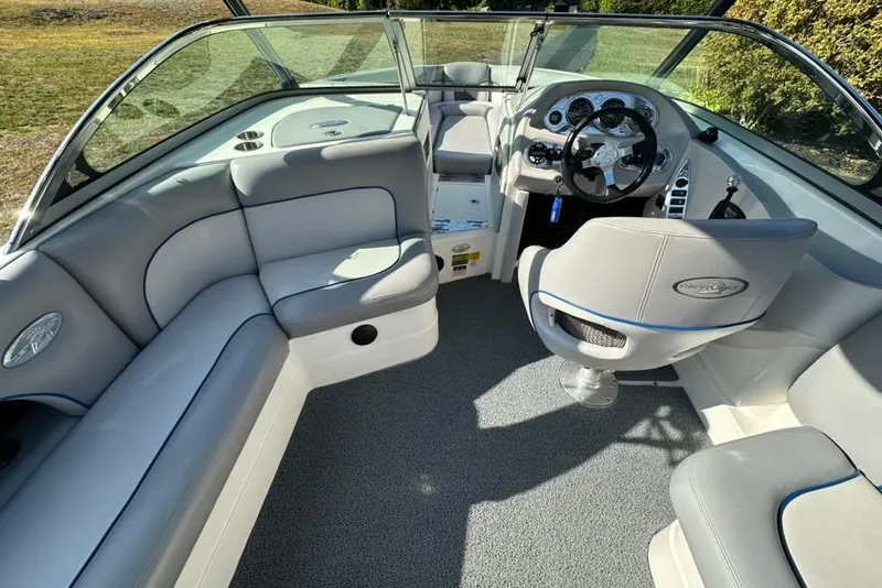 Slide: The Image of 2006 Centurion Enzo SV230 boat interior with gray seating and steering console. - 14