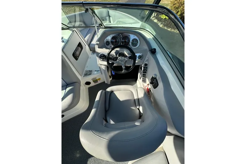 Slide: The Image of 2006 Centurion Enzo SV230 boat interior with steering wheel and dashboard controls. - 16