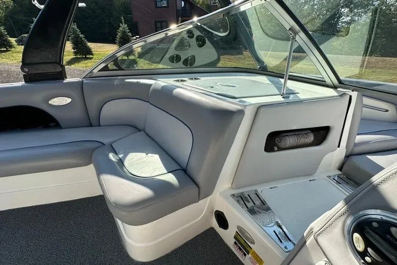 Slide: The Image of Interior of a 2006 Centurion Enzo SV230 boat with gray seating and dashboard. - 18