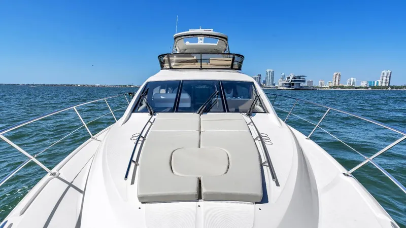 Slide: The Image of 2015 Sea Ray 510 Fly yacht on open water, featuring sleek design and luxurious amenities. - 9