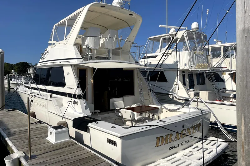 The Image of 1987 Bertram 42 Convertible yacht docked at marina, featuring spacious deck and elegant design. - 0