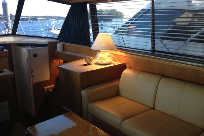 Slide: The Image of Interior of 1987 Bertram 42 Convertible yacht with cozy seating and nautical decor. - 13