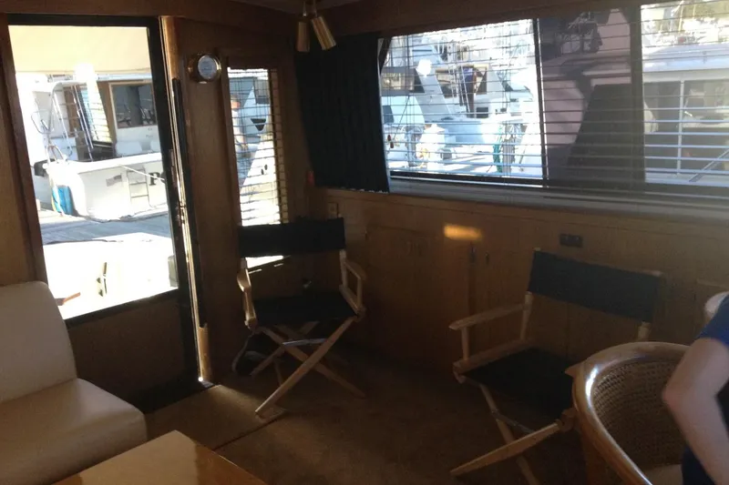 Slide: The Image of Interior of 1987 Bertram 42 Convertible yacht with chairs and window view. - 15