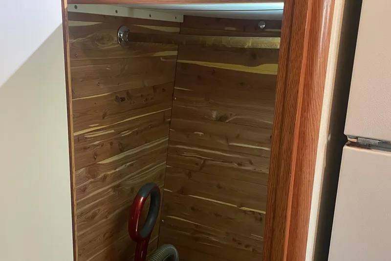 Slide: The Image of Wood-paneled closet interior on 1987 Bertram 42 Convertible boat. - 17