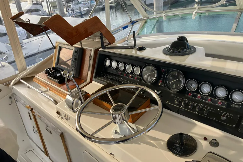 Slide: The Image of Cockpit of a 1987 Bertram 42 Convertible yacht with steering wheel and instrument panel. - 20