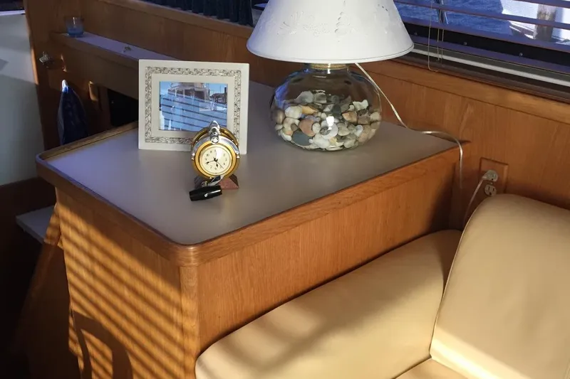 Slide: The Image of Interior of 1987 Bertram 42 Convertible with lamp, clock, and framed photo on table. - 7