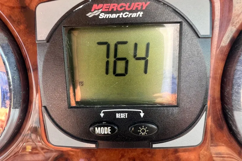 Slide: The Image of 2003 Sea Ray 240 Sundeck interior with portable toilet and sink. - 14