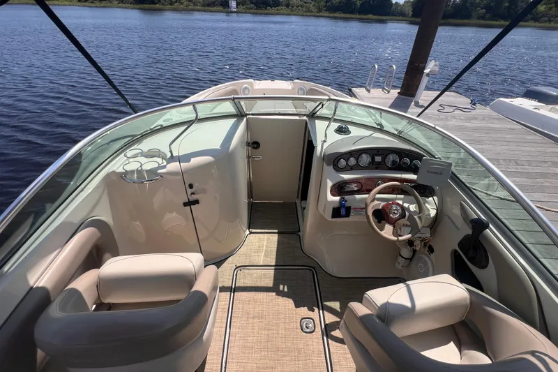 Slide: The Image of 2003 Sea Ray 240 Sundeck interior with steering wheel and captain's chair. - 9