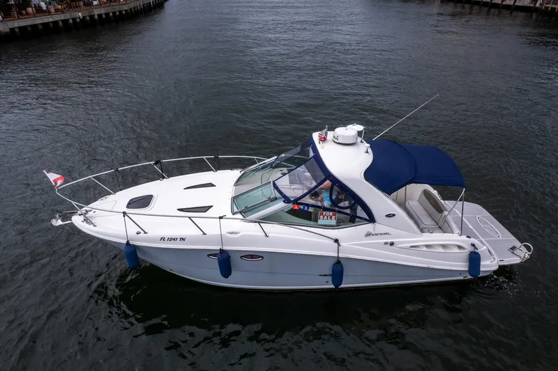 Slide: The Image of 2007 Sea Ray 290 Sundancer boat on water, for sale sign visible. - 11