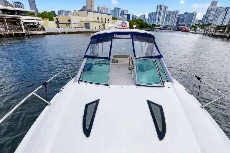 Slide: The Image of 2007 Sea Ray 290 Sundancer yacht cruising in urban waterway with city skyline. - 12