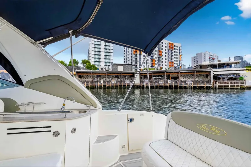Slide: The Image of 2007 Sea Ray 290 Sundancer yacht docked near waterfront buildings. - 15