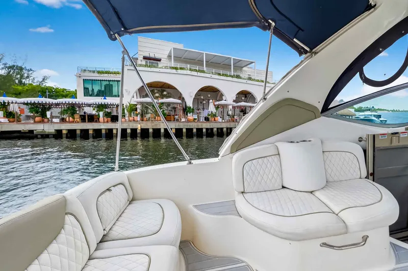 Slide: The Image of 2007 Sea Ray 290 Sundancer boat interior with waterfront view and modern building. - 18