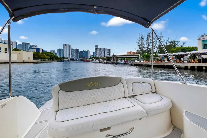 Slide: The Image of 2007 Sea Ray 290 Sundancer boat with city skyline view, under a blue sky. - 19