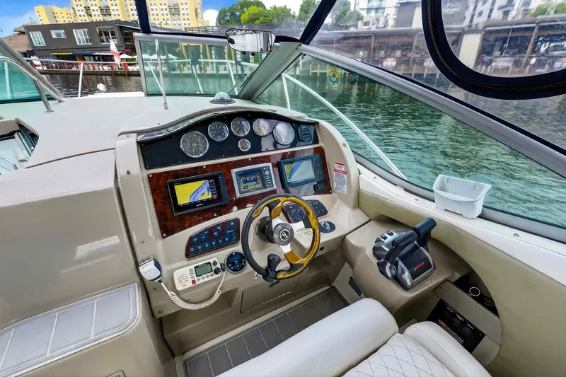 Slide: The Image of 2007 Sea Ray 290 Sundancer helm with navigation instruments and luxurious seating. - 21