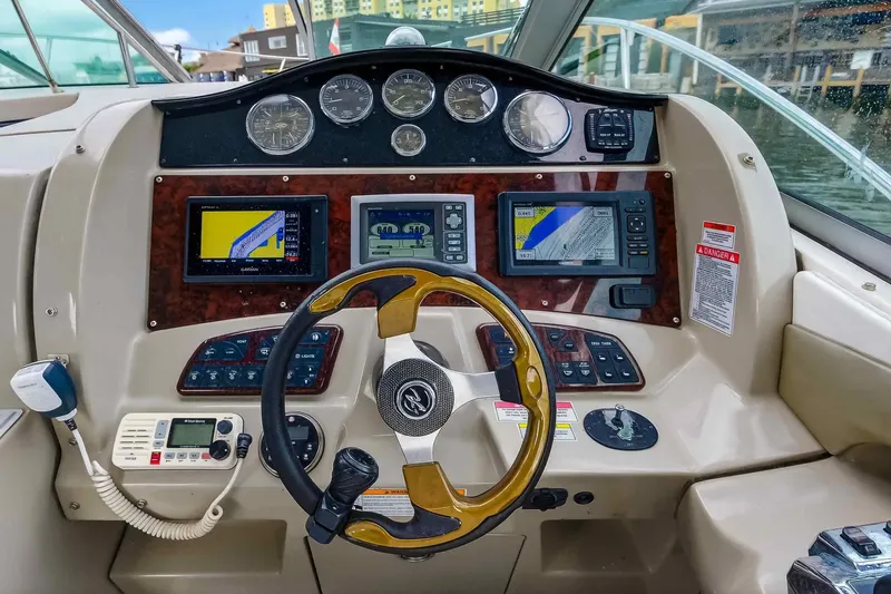 Slide: The Image of 2007 Sea Ray 290 Sundancer helm with navigation screens and controls. - 22