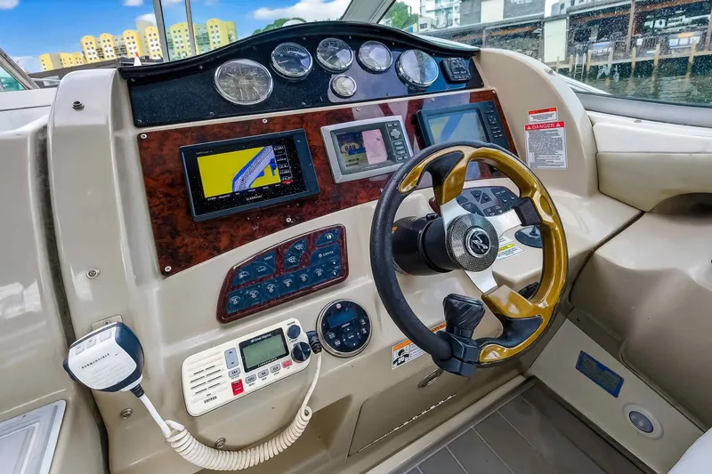 Slide: The Image of 2007 Sea Ray 290 Sundancer helm with navigation instruments and steering wheel. - 24