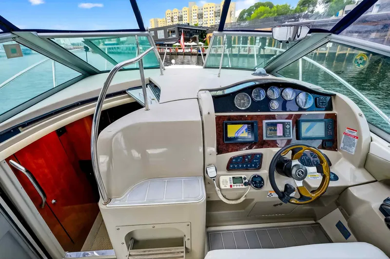 Slide: The Image of 2007 Sea Ray 290 Sundancer helm with modern navigation instruments and luxurious interior. - 25