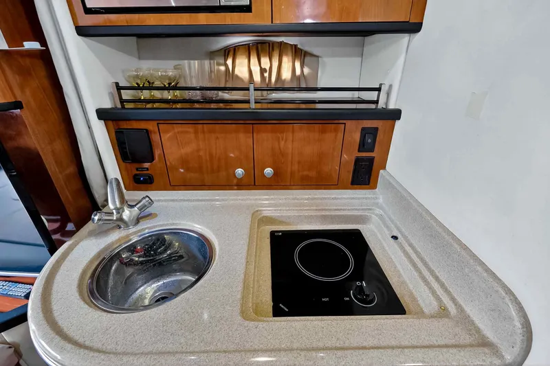 Slide: The Image of 2007 Sea Ray 290 Sundancer galley with sink and stovetop. - 34
