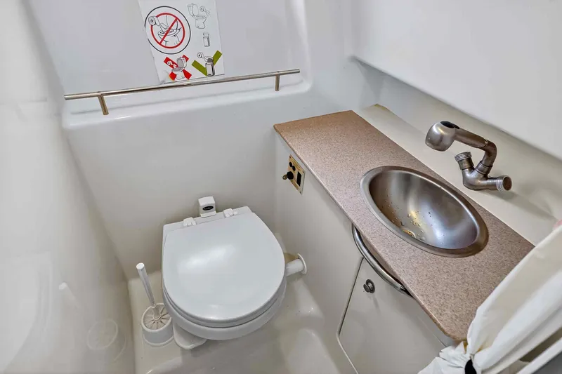 Slide: The Image of 2007 Sea Ray 290 Sundancer bathroom with toilet and sink. - 38