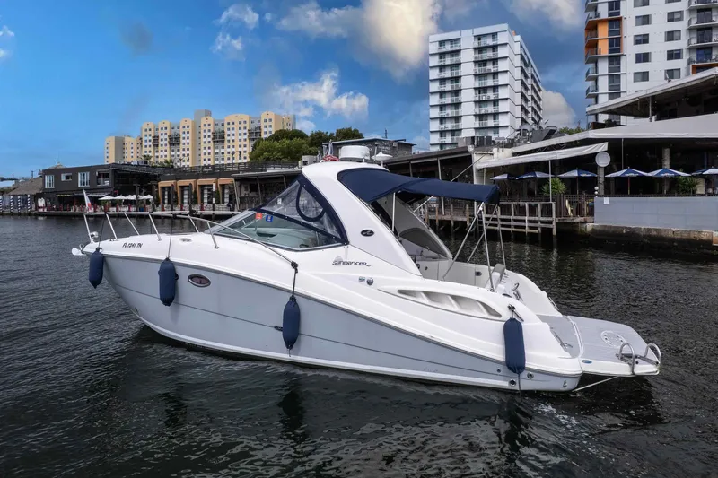 Slide: The Image of 2007 Sea Ray 290 Sundancer boat docked near urban waterfront buildings. - 4