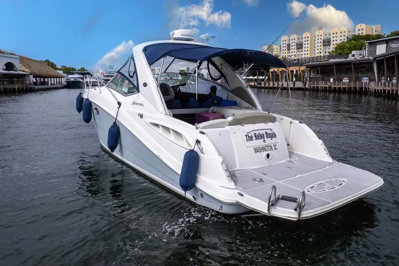 Slide: The Image of 2007 Sea Ray 290 Sundancer yacht cruising in a scenic marina setting. - 5