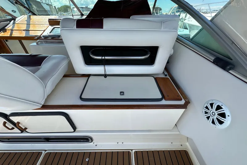Slide: The Image of 1987 Sea Ray 340 Sundancer interior with white seating and wooden accents. - 15