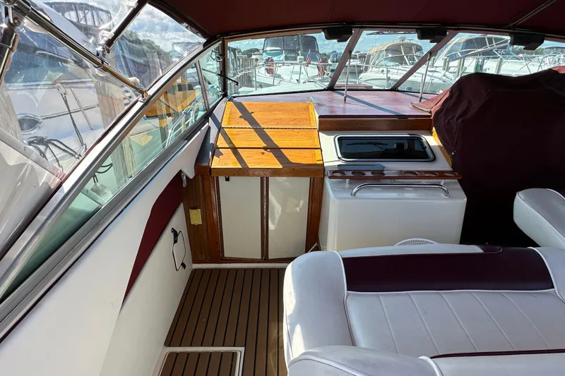 Slide: The Image of 1987 Sea Ray 340 Sundancer interior with wood accents and seating. - 16