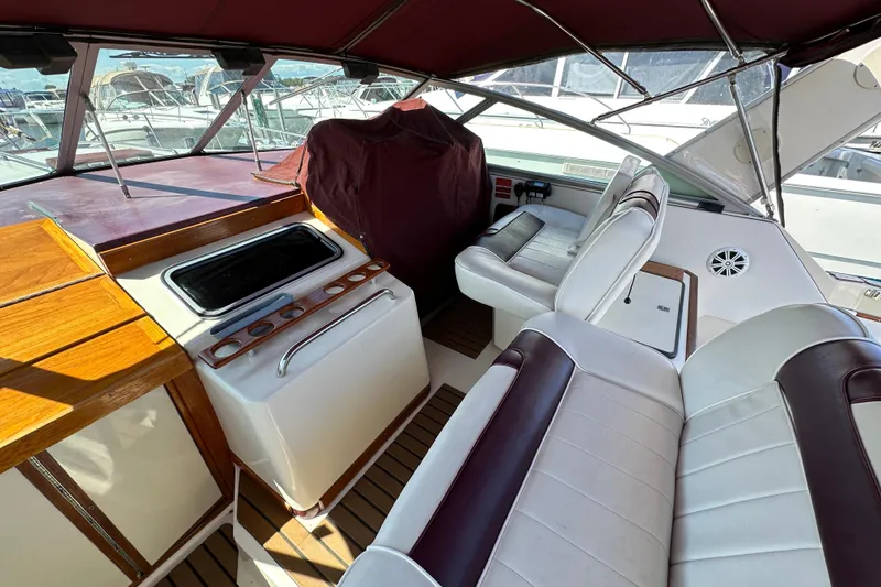 Slide: The Image of 1987 Sea Ray 340 Sundancer interior with white seating and wooden accents. - 17