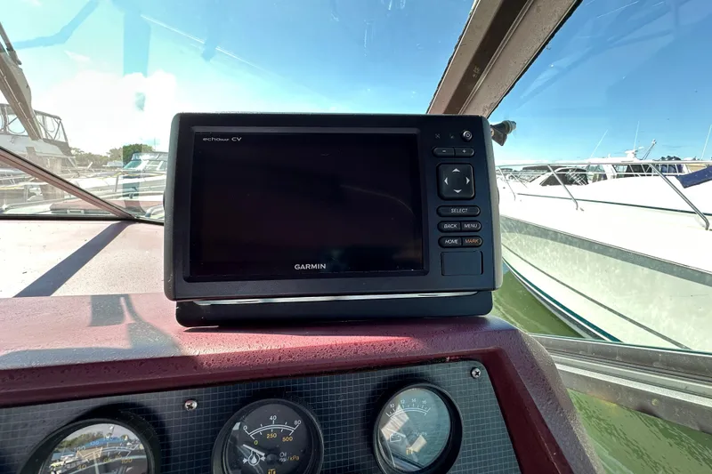 Slide: The Image of Garmin navigation system on 1987 Sea Ray 340 Sundancer boat dashboard, with gauges visible. - 22