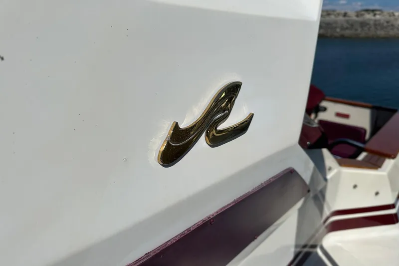 Slide: The Image of 1987 Sea Ray 340 Sundancer boat emblem with maroon interior accents. - 3