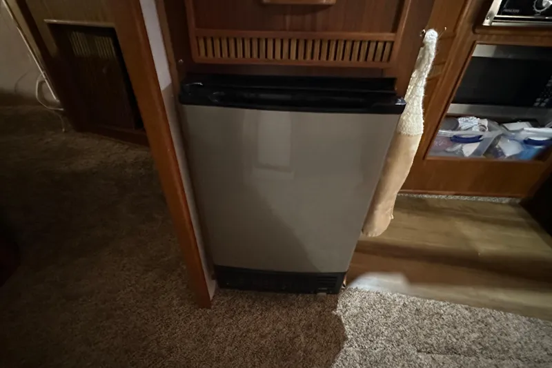 Slide: The Image of Compact refrigerator inside 1987 Sea Ray 340 Sundancer yacht cabin, with wooden cabinetry. - 34
