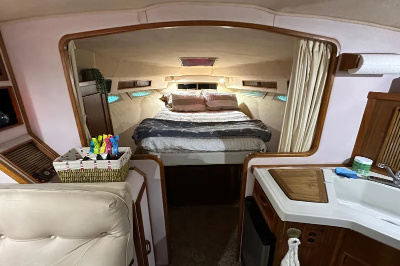 Slide: The Image of Interior of 1987 Sea Ray 340 Sundancer with cozy bed and compact kitchenette. - 35