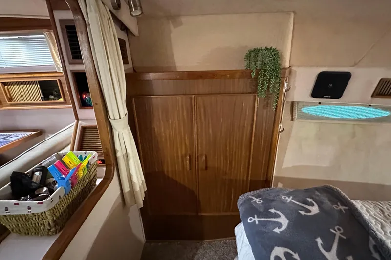 Slide: The Image of Interior of 1987 Sea Ray 340 Sundancer with wooden cabinetry and nautical decor. - 39