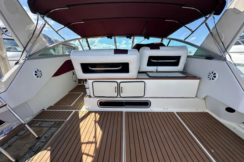 Slide: The Image of 1987 Sea Ray 340 Sundancer interior with wood flooring and white seating. - 6
