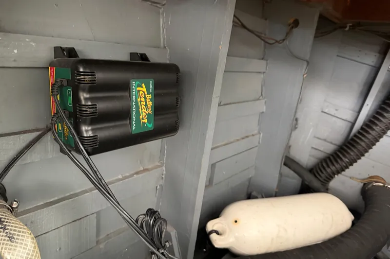 Slide: The Image of Battery Tender device in a 1964 Shepherd 22 boat interior with wiring and fender. - 20